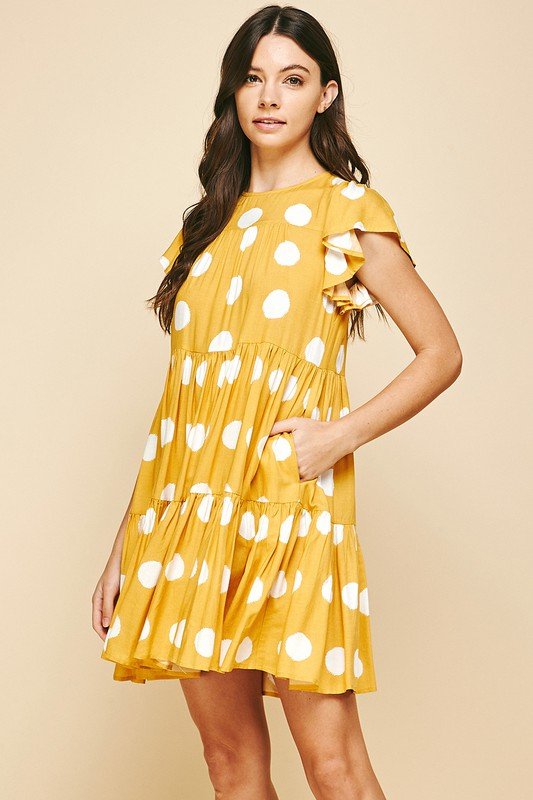 Sunshine and Dots Dress showcasing a trendy coastal style, perfect for summer outfits at Raggdoll Boutique.