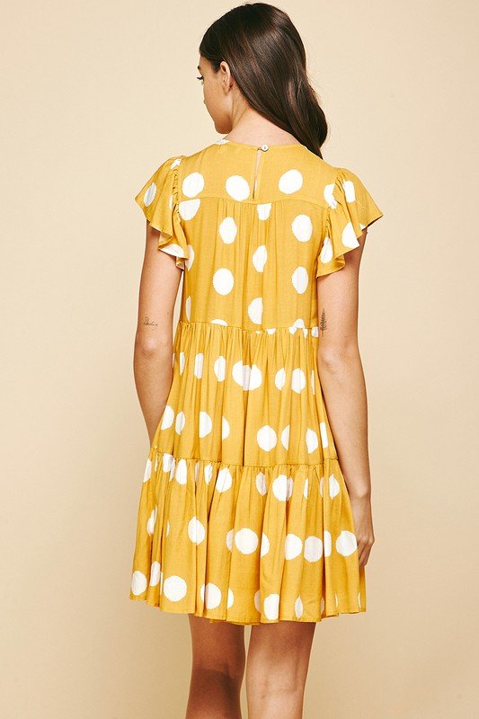 Back view of a woman wearing the Sunshine and Dots Dress from Raggdoll Boutique, perfect for summer outfits Texas.