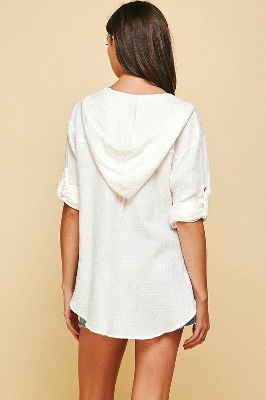 Back view of a woman wearing a White Hooded Casual Top from Raggdoll Boutique, ideal for summer outfits Texas.