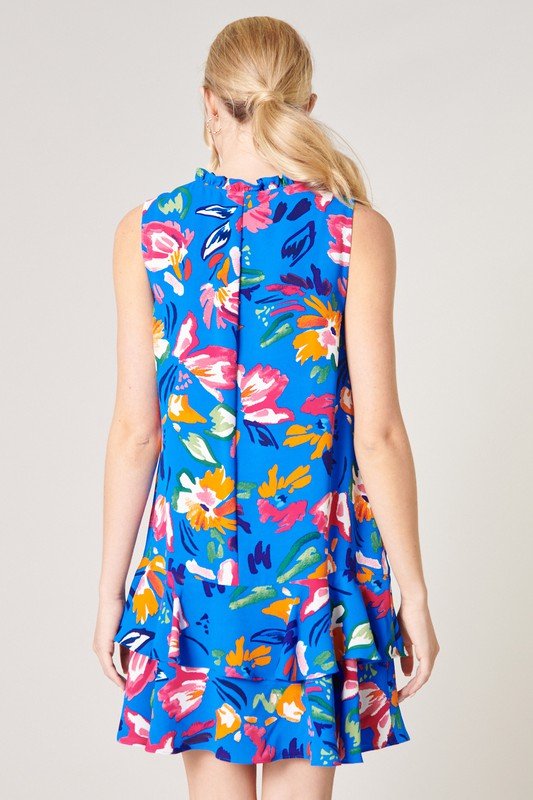 Product image of the SUMMERTIME BLUE DRESS featuring a colorful floral design and ruffled hem, ideal for summer outfits Texas.
