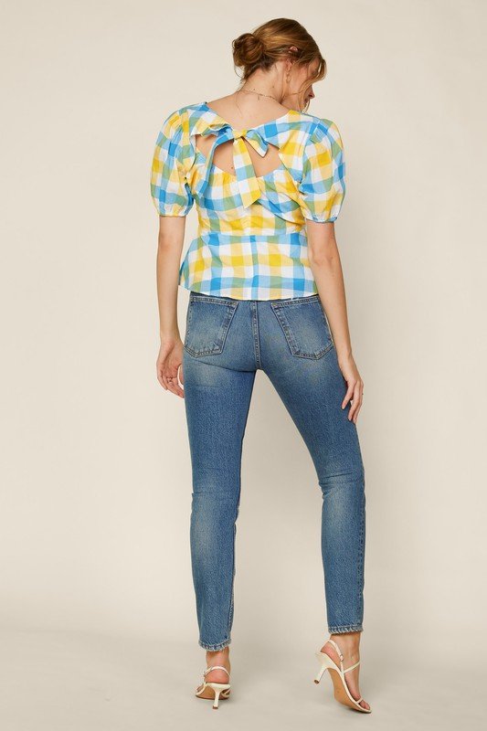 Model wearing BLUE YELLOW GINGHAM TIE BACK PEPLUM top with jeans, showcasing trendy coastal style from Raggdoll Boutique.