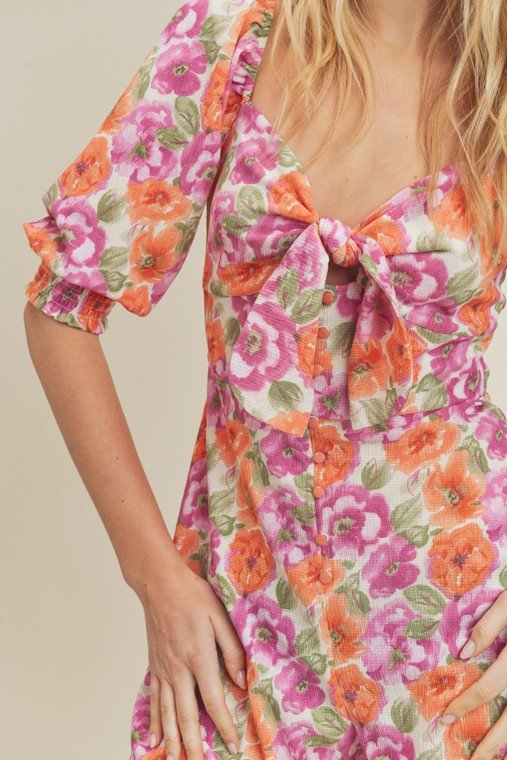 BLOSSOMS ABOUND ROMPER featuring a floral design in vibrant pink and orange, perfect for summer outfits Texas from Raggdoll Boutique.