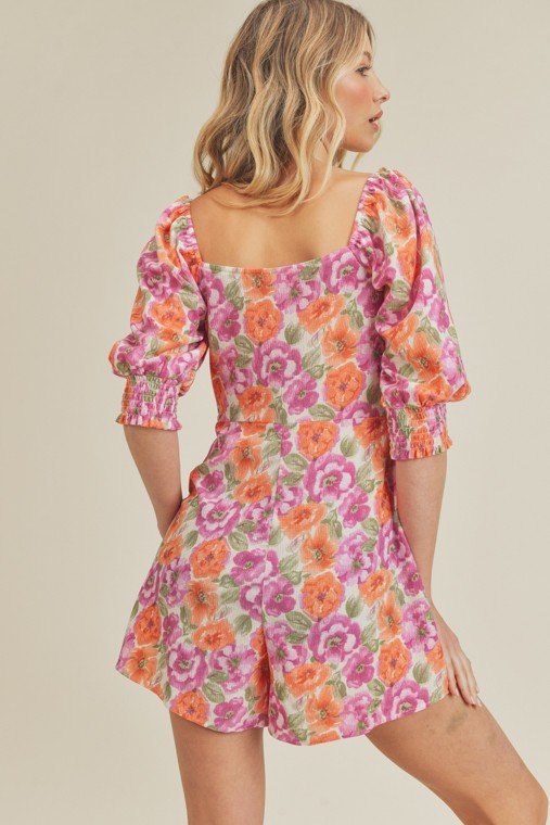 BLOSSOMS ABOUND ROMPER from Raggdoll Boutique features a vibrant floral design, perfect for trendy coastal style and summer outfits in Texas.