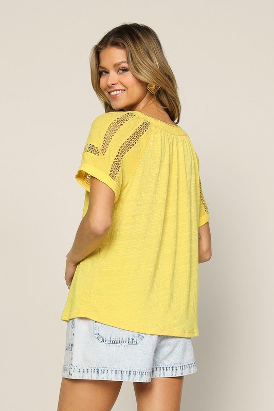 Back view of a woman wearing a POWDER YELLOW LACE DETAIL TOP from Raggdoll Boutique, perfect for summer outfits Texas.