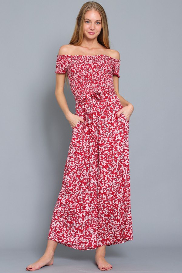 Model wearing a red and white smocked jumpsuit from Raggdoll Boutique, ideal for summer outfits Texas.