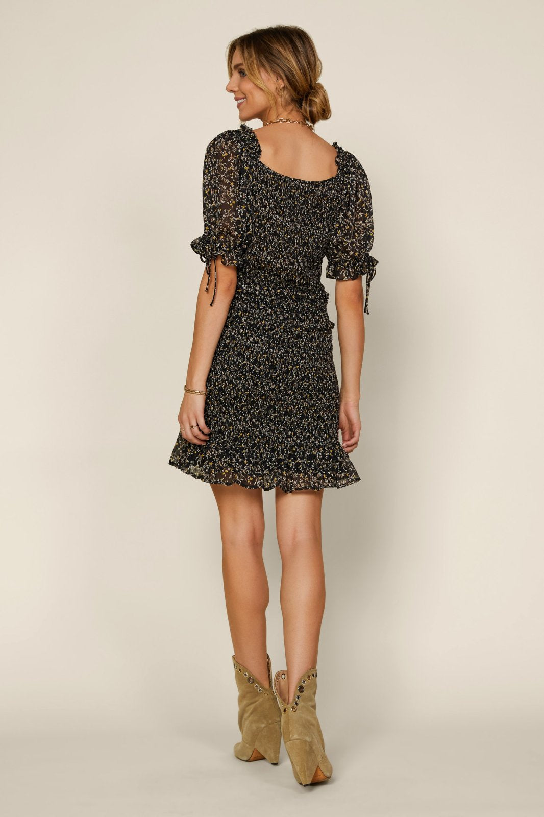 Carley Dress from a coastal boutique, perfect for stylish beach outings, featuring trendy sleeves and feminine design.
