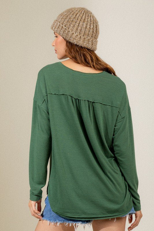 FOREST GREEN BUTTON DOWN HENLEY styled with a cozy beanie, perfect for trendy coastal style at Raggdoll Boutique.
