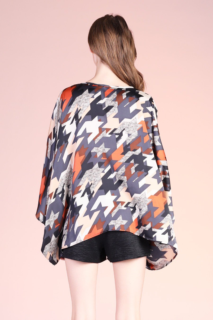 NAVY GRAPHIC CAFTAN TOP shown from the back, featuring bold colorful patterns, perfect for trendy coastal style.