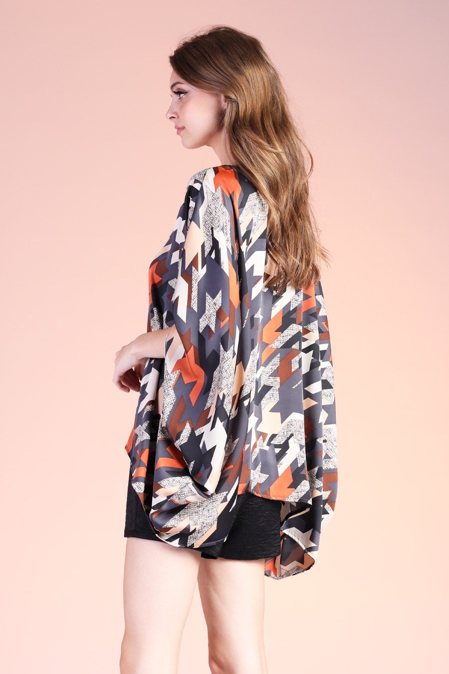 Navy graphic caftan top styled for trendy coastal fashion, perfect from Raggdoll Boutique in Port Aransas.