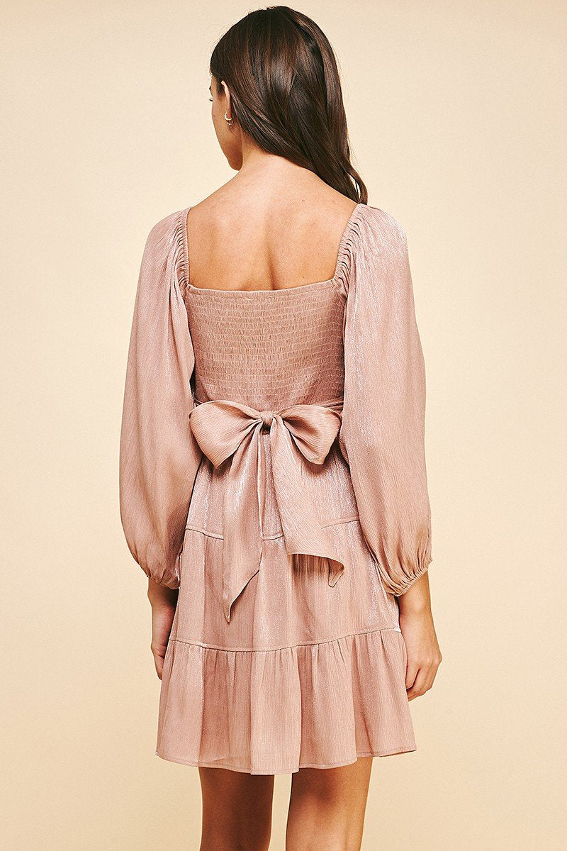 Back view of SLIGHT SHIMMER DRESS featuring puff sleeves and a bow detail, perfect for summer outfits Texas from Raggdoll Boutique.