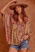 Woman wearing the MULTI WITH TURQUOISE SAVANNA JANE TOP paired with shorts and a hat from Raggdoll Boutique.