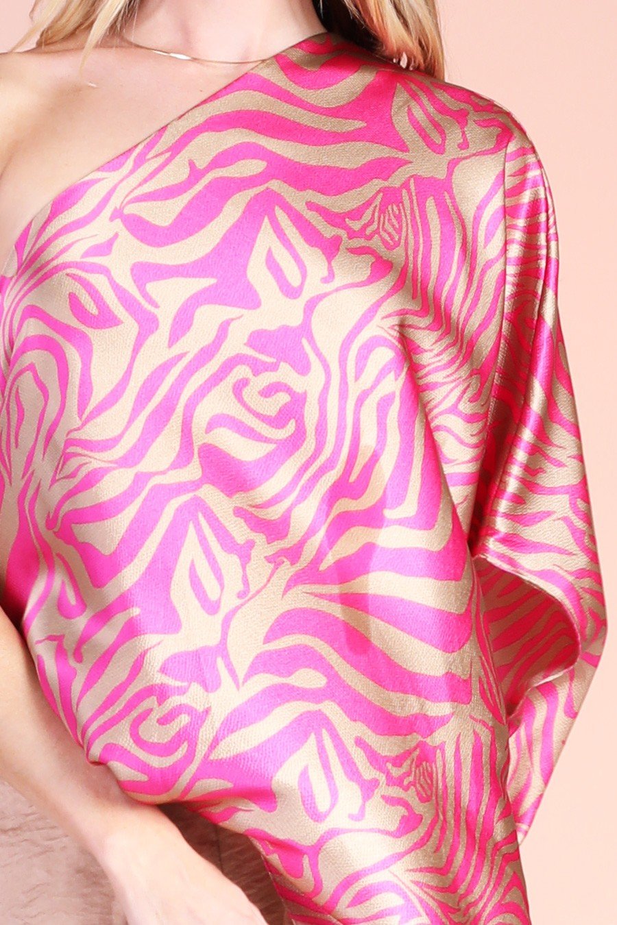 PINK AND BRUSHED GOLD ONE-SHOULDER TOP styled with a vibrant zebra pattern, from Raggdoll Boutique.