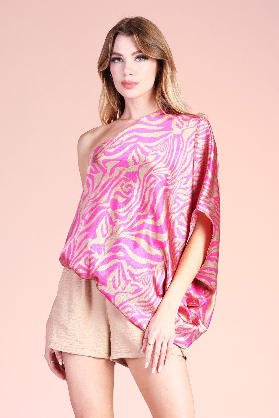 PINK AND BRUSHED GOLD ONE-SHOULDER TOP modeled with trendy shorts from Raggdoll Boutique, perfect for summer outfits Texas.
