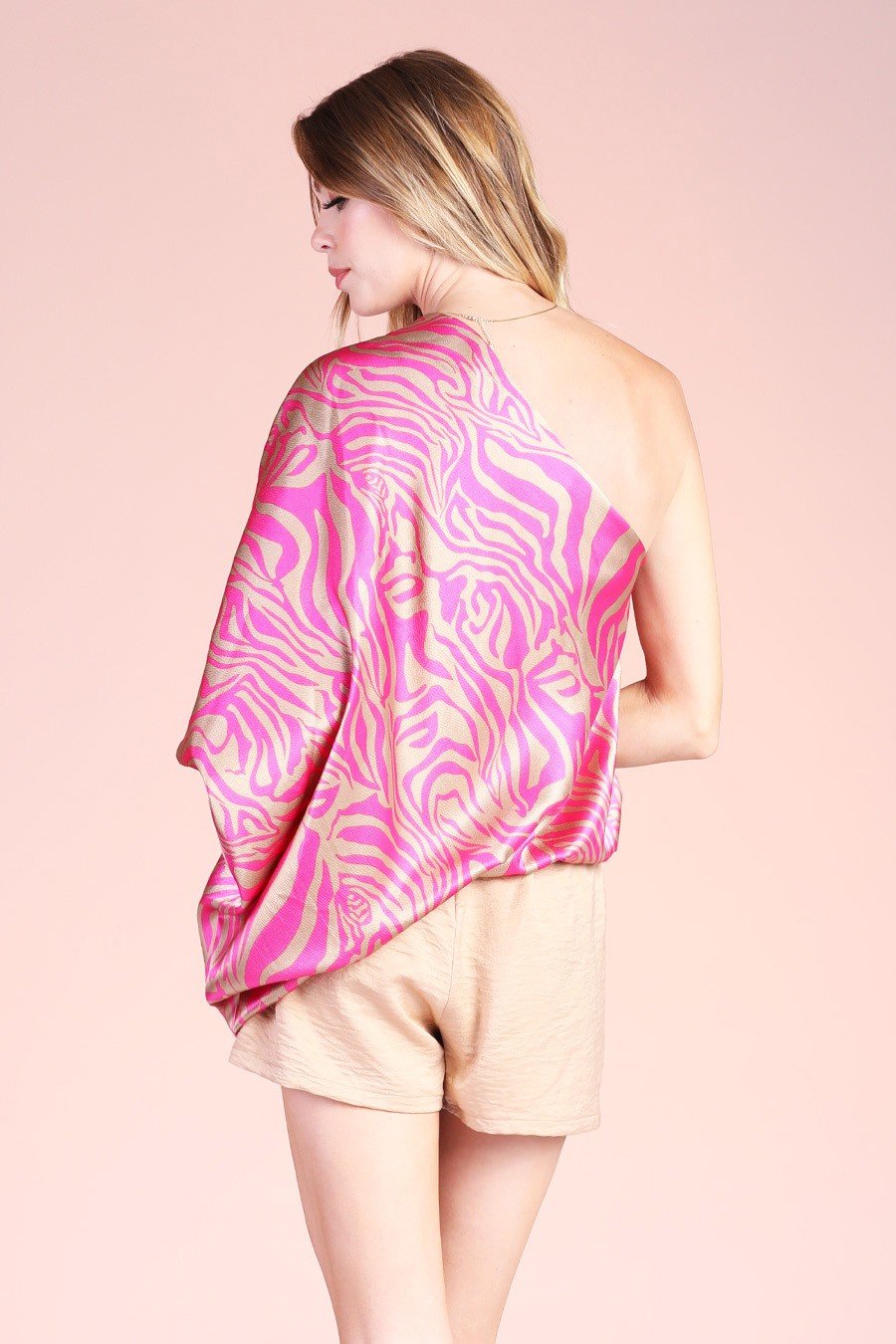 PINK AND BRUSHED GOLD ONE-SHOULDER TOP displayed on model showcasing trendy coastal style at Raggdoll Boutique.