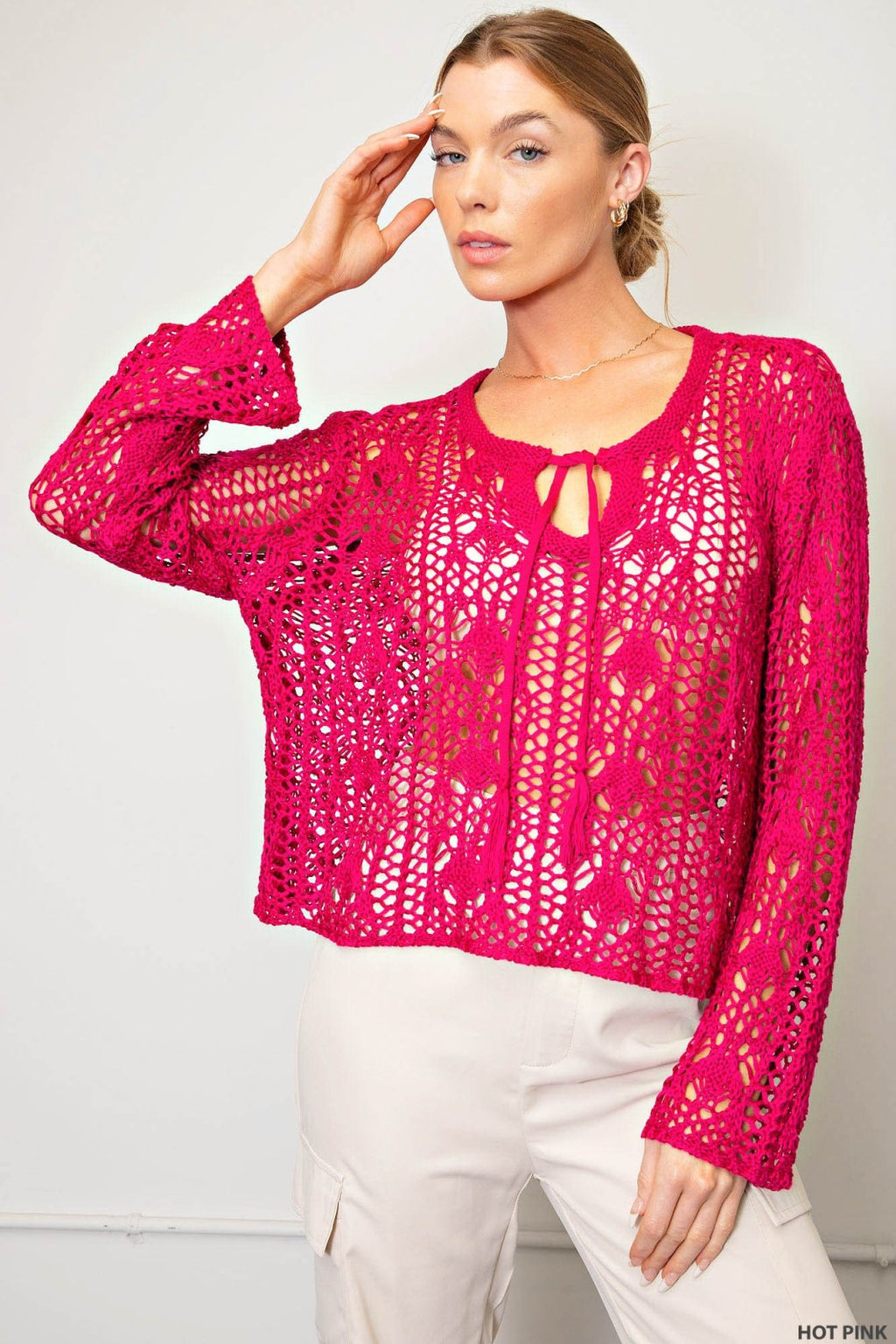 Stylish hot pink crocheted boho sweater, ideal for coastal boutique clothing and tropical vacations. Perfect for women's fashion.