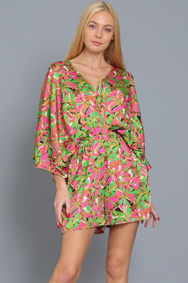 Model wearing GREEN/PINK PRINT DOLMAN SLEEVE ROMPER from Raggdoll Boutique, perfect for trendy coastal style.