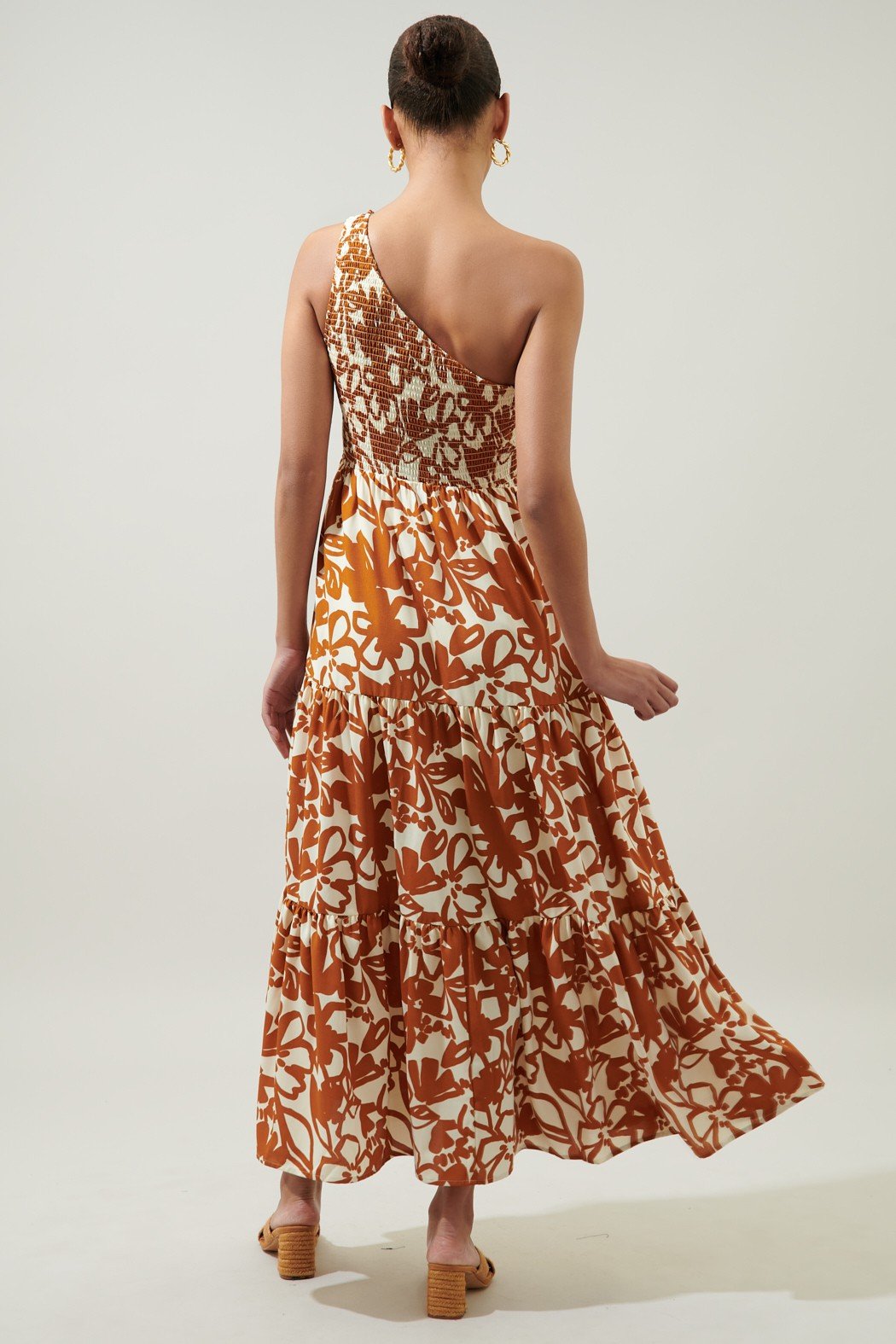 Back view of the MARIDA CARAMEL FLORAL ONE SHOULDER DRESS from Raggdoll Boutique, perfect for trendy coastal style.