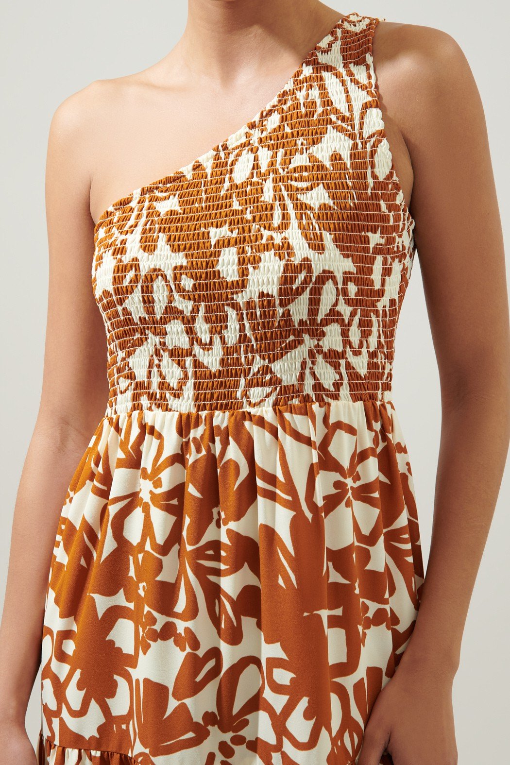 MARIDA CARAMEL FLORAL ONE SHOULDER DRESS showcased in a chic coastal style, perfect for summer outfits and vacation wardrobe.