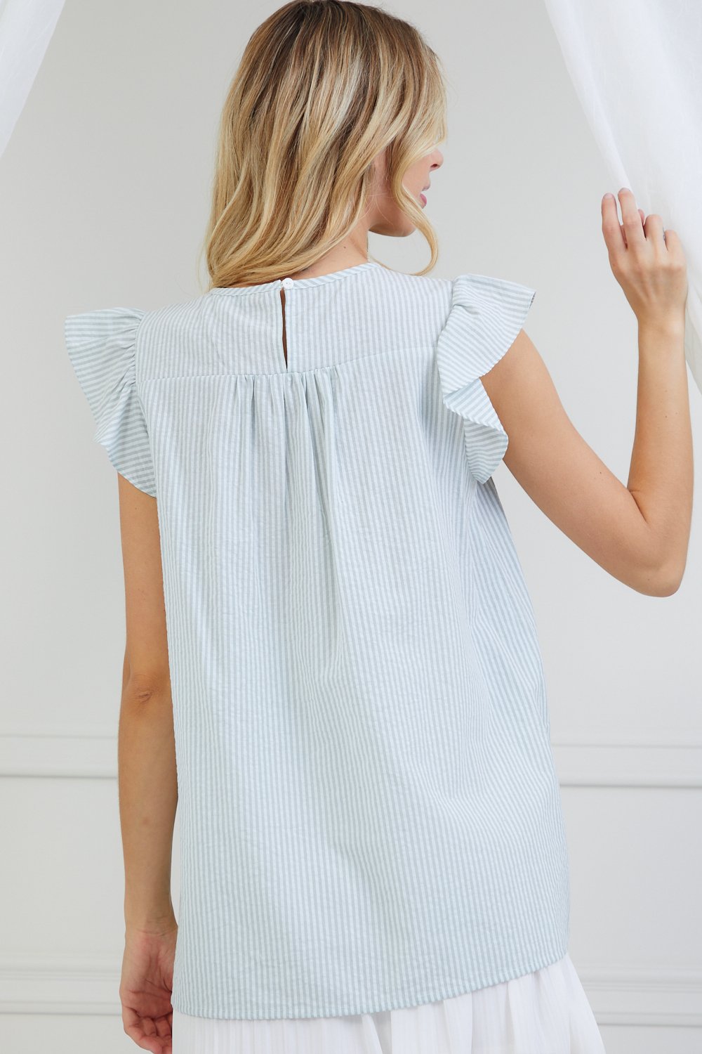 Mint floral embroidered striped top, ideal for coastal boutique clothing and stylish women's fashion. Perfect for summer outings.