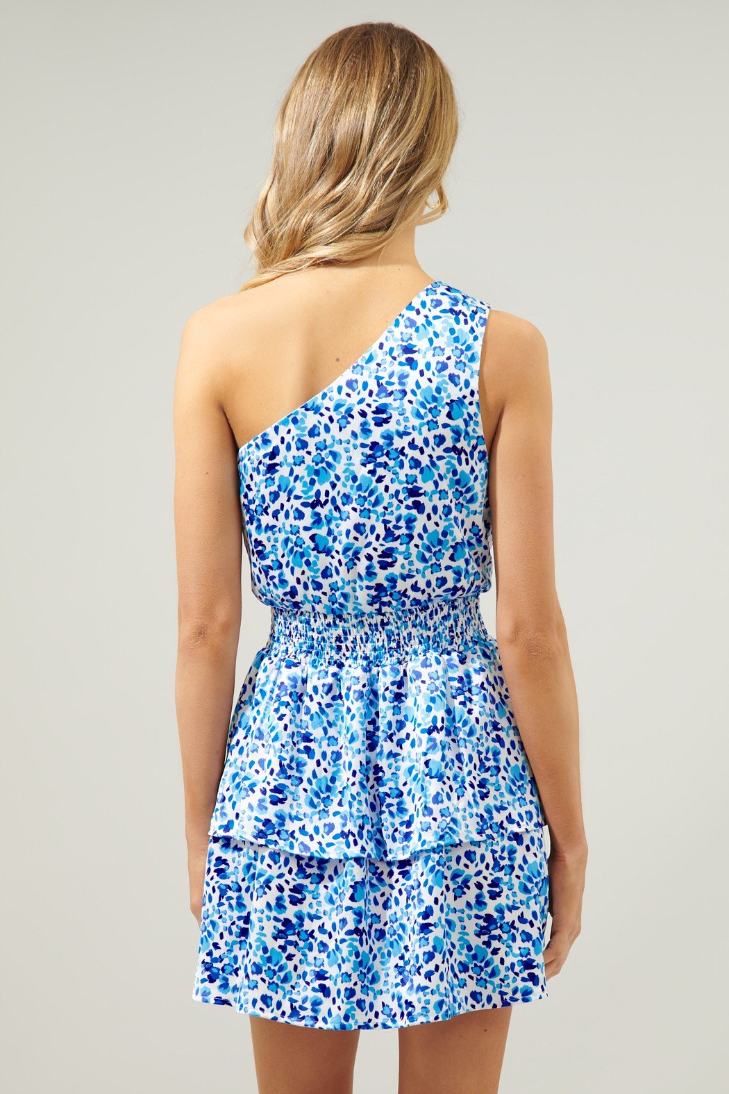 Back view of the GUEST OF HONOR DRESS in blue floral, part of coastal boutique clothing for tropical vacations.