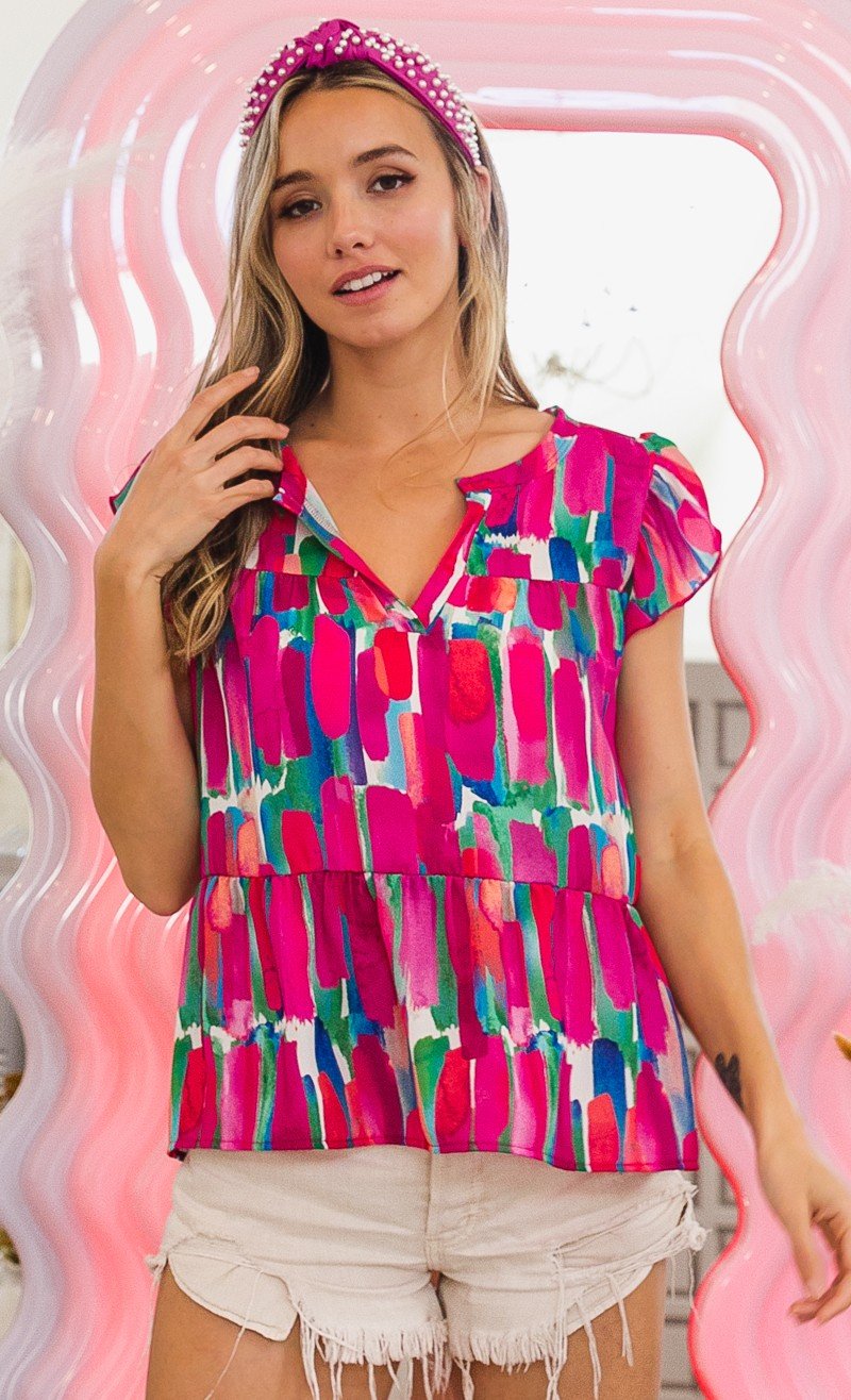 FUSHIA AND BLUE TOP worn with shorts, showcasing trendy coastal style at Raggdoll Boutique in Port Aransas.