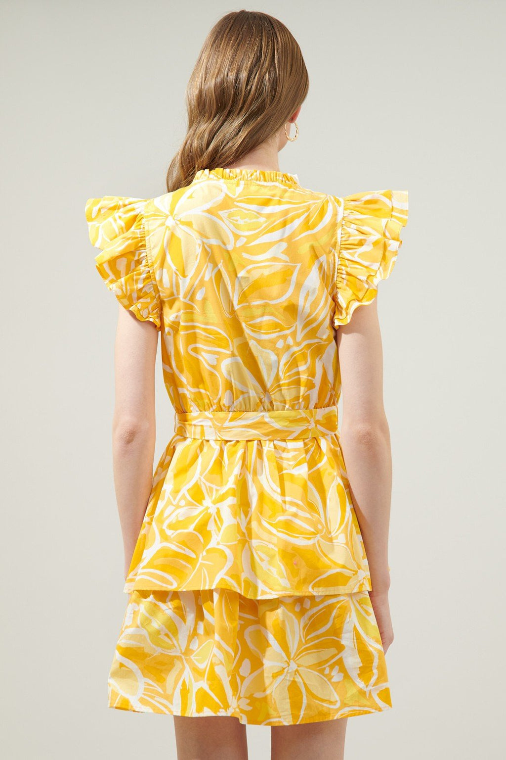 WALKING ON SUSNSHINE DRESS from Raggdoll Boutique features flutter sleeves and a vibrant yellow floral print.