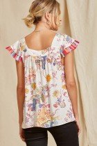 Savanna Jane top with tassels featuring colorful patterns and ruffle sleeves at Raggdoll Boutique, Port Aransas.