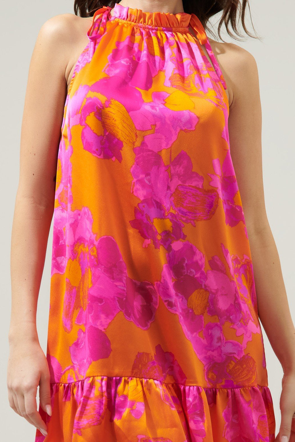 Vibrant fuchsia floral halter dress on model, perfect for coastal boutique clothing and tropical vacations.