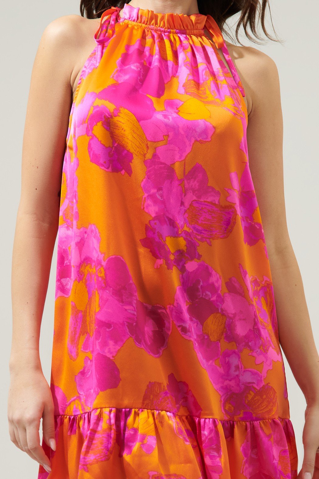 Vibrant fuchsia floral halter dress on model, perfect for coastal boutique clothing and tropical vacations.