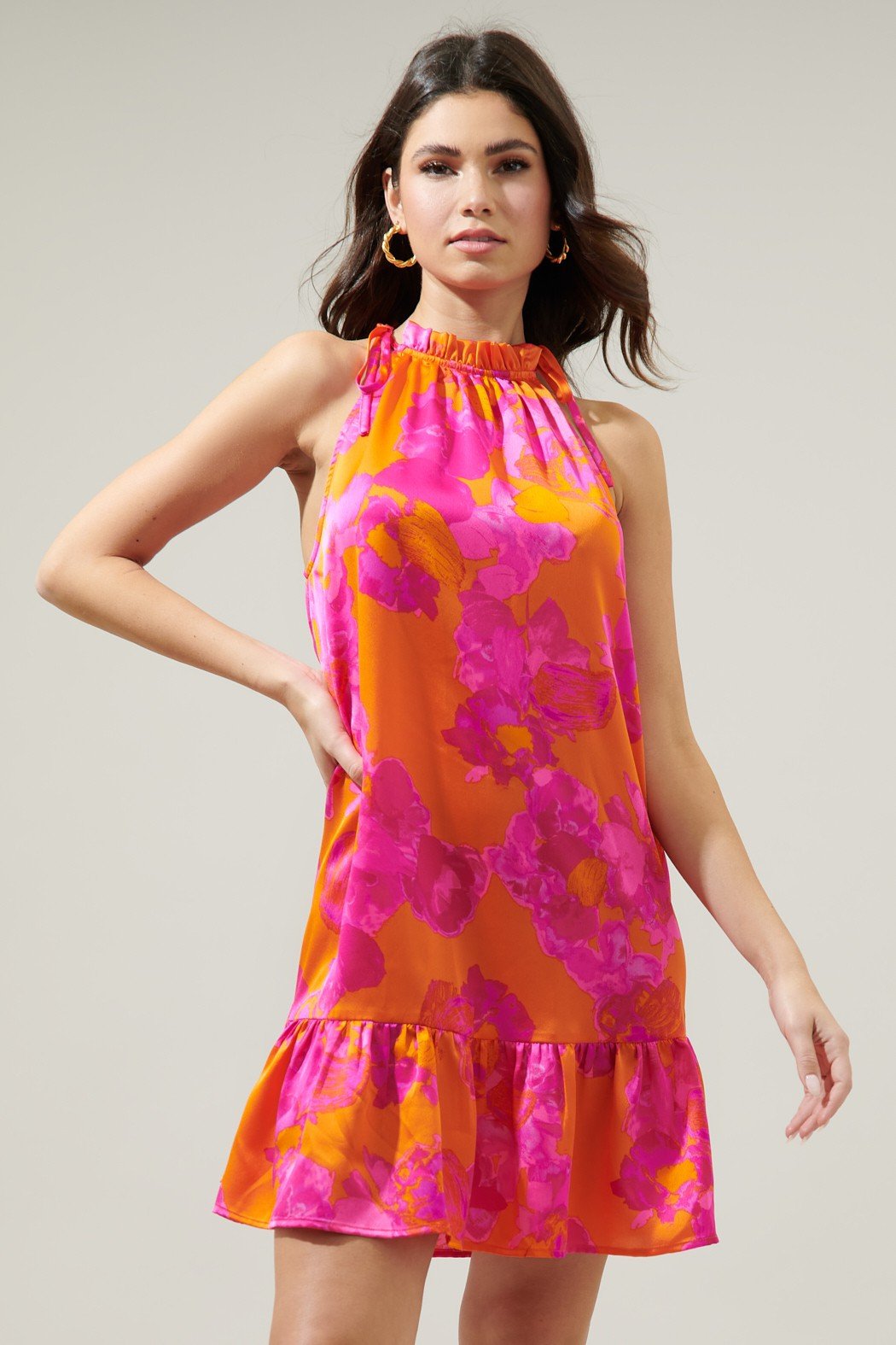 Vibrant fuchsia floral halter dress with ruffle hem, perfect for coastal boutique clothing and tropical vacations.
