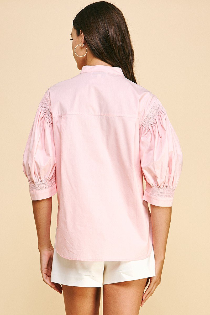 Back view of SWEET PINK SMOCKED SLEEVE TOP from Raggdoll Boutique, perfect for summer outfits in Texas.