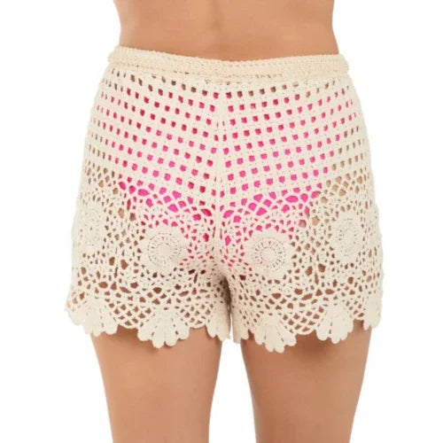 Natural crochet cover shorts with delicate lace design, perfect for beachside wear in coastal boutique clothing.