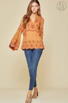 RUST EMBELLISHED BELL SLEEVE TOP showcased with trendy jeans, perfect for coastal fashion boutique outfits.