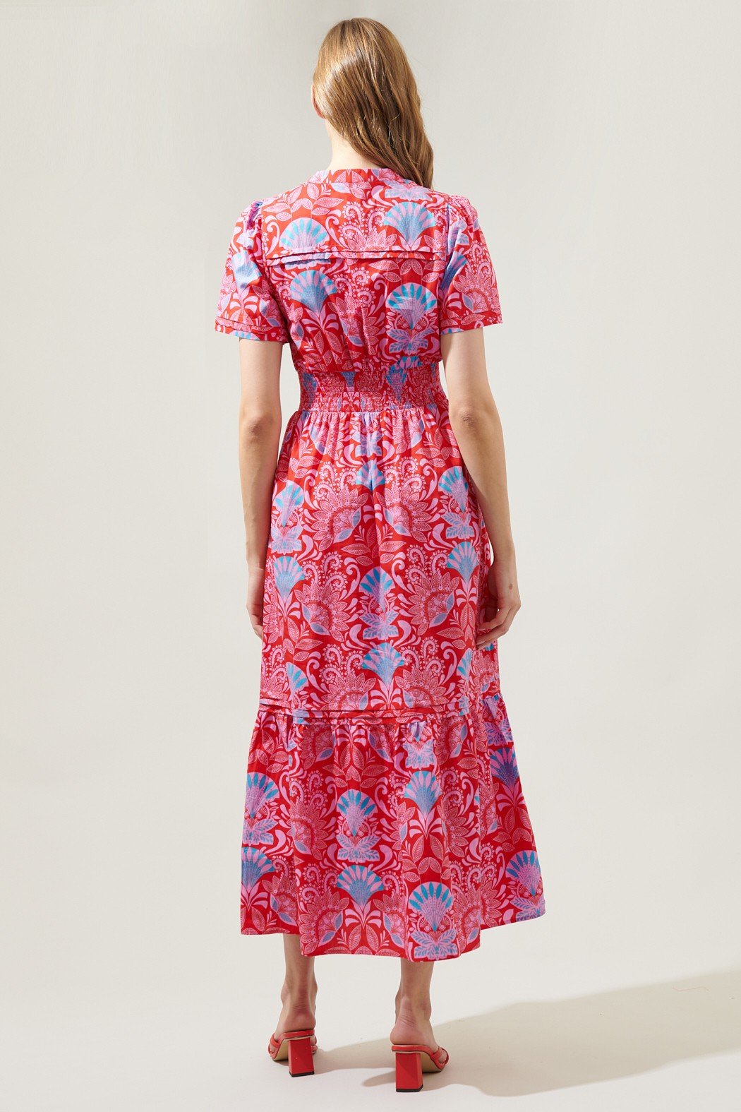 Back view of a vibrant pink patterned dress from Raggdoll Boutique, embodying trendy coastal style. PRETTY AS A PICTURE.