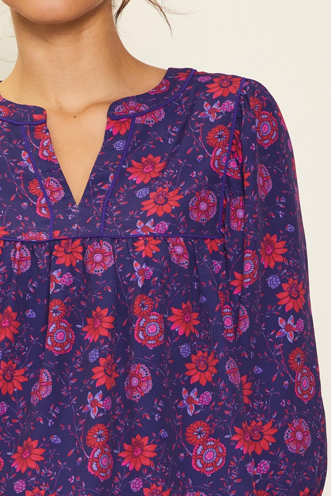 GRAPE-RED PRINTED BLOUSE from Raggdoll Boutique featuring vibrant floral prints and a trendy coastal style.