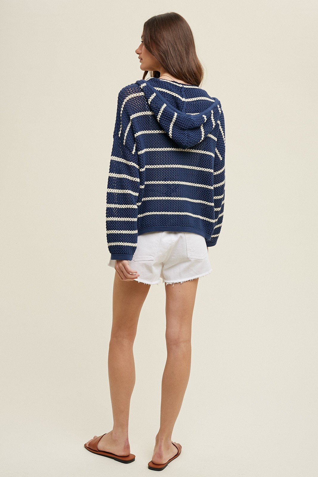 Model wearing NAVY/ECRU STRIPED KNIT SWEATER from Raggdoll Boutique, ideal for trendy coastal style.