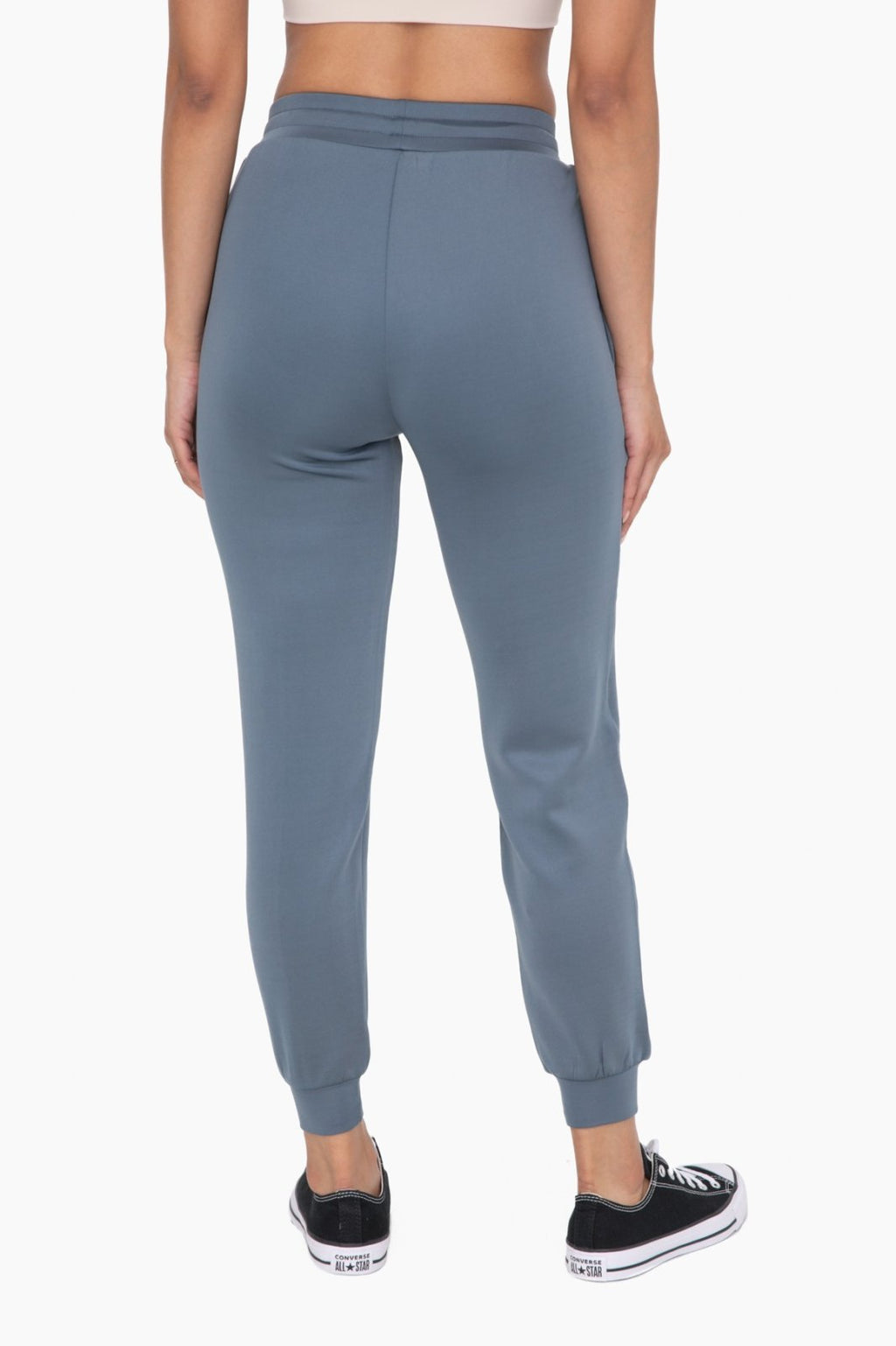 Back view of stylish blue cuffed joggers with zipper pockets, perfect for coastal boutique clothing and curvy plus size fashion.