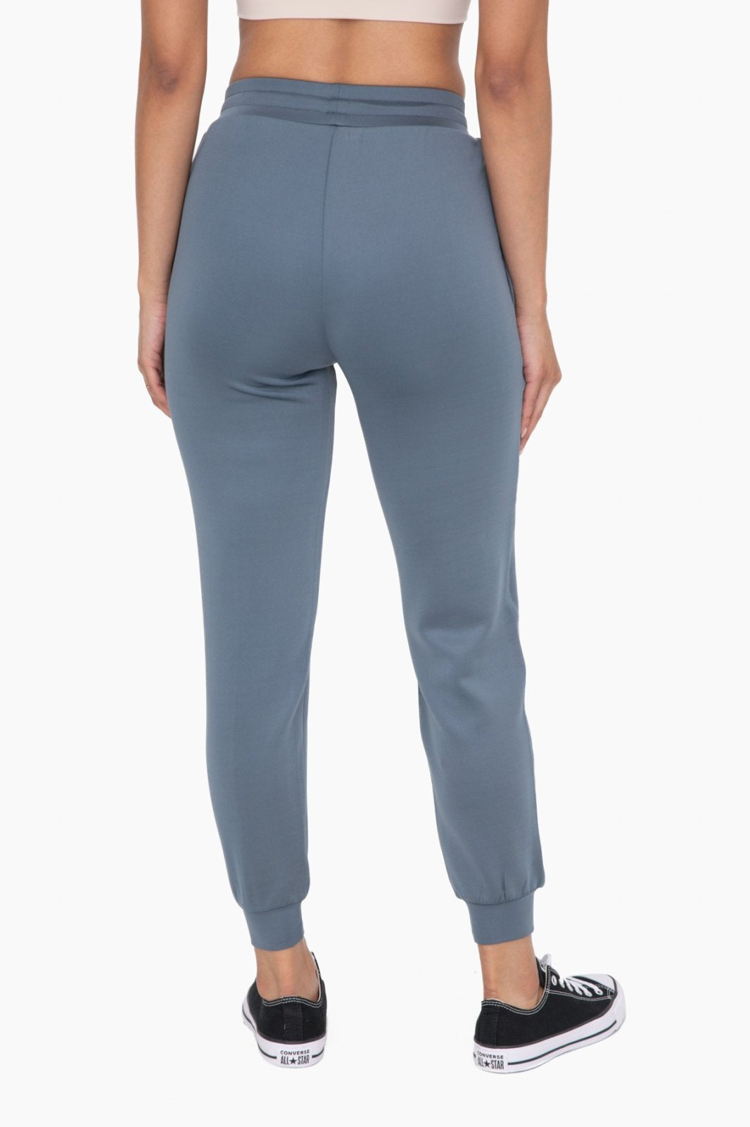Back view of stylish blue cuffed joggers with zipper pockets, perfect for coastal boutique clothing and curvy plus size fashion.