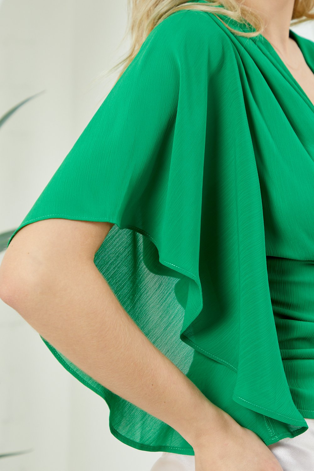 KELLY GREEN TOP with ruched detail and flair sleeves from Raggdoll Boutique, perfect for trendy coastal style.