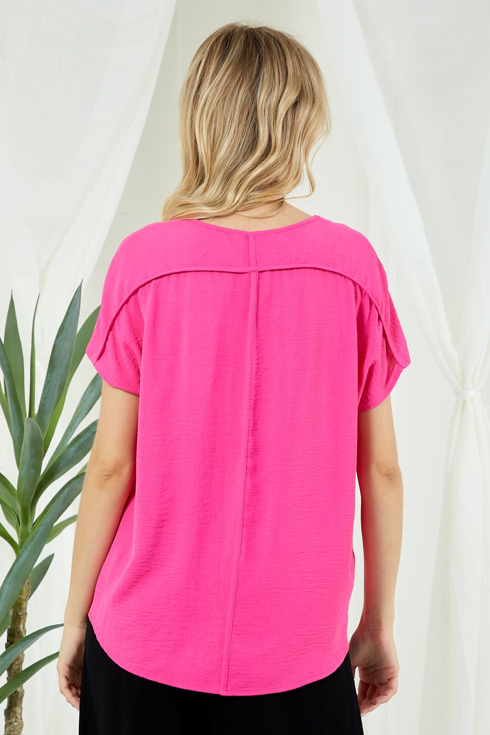 Back view of HOT PINK V-NECK SOLID SIMPLE TOP from Raggdoll Boutique, perfect for trendy coastal style.