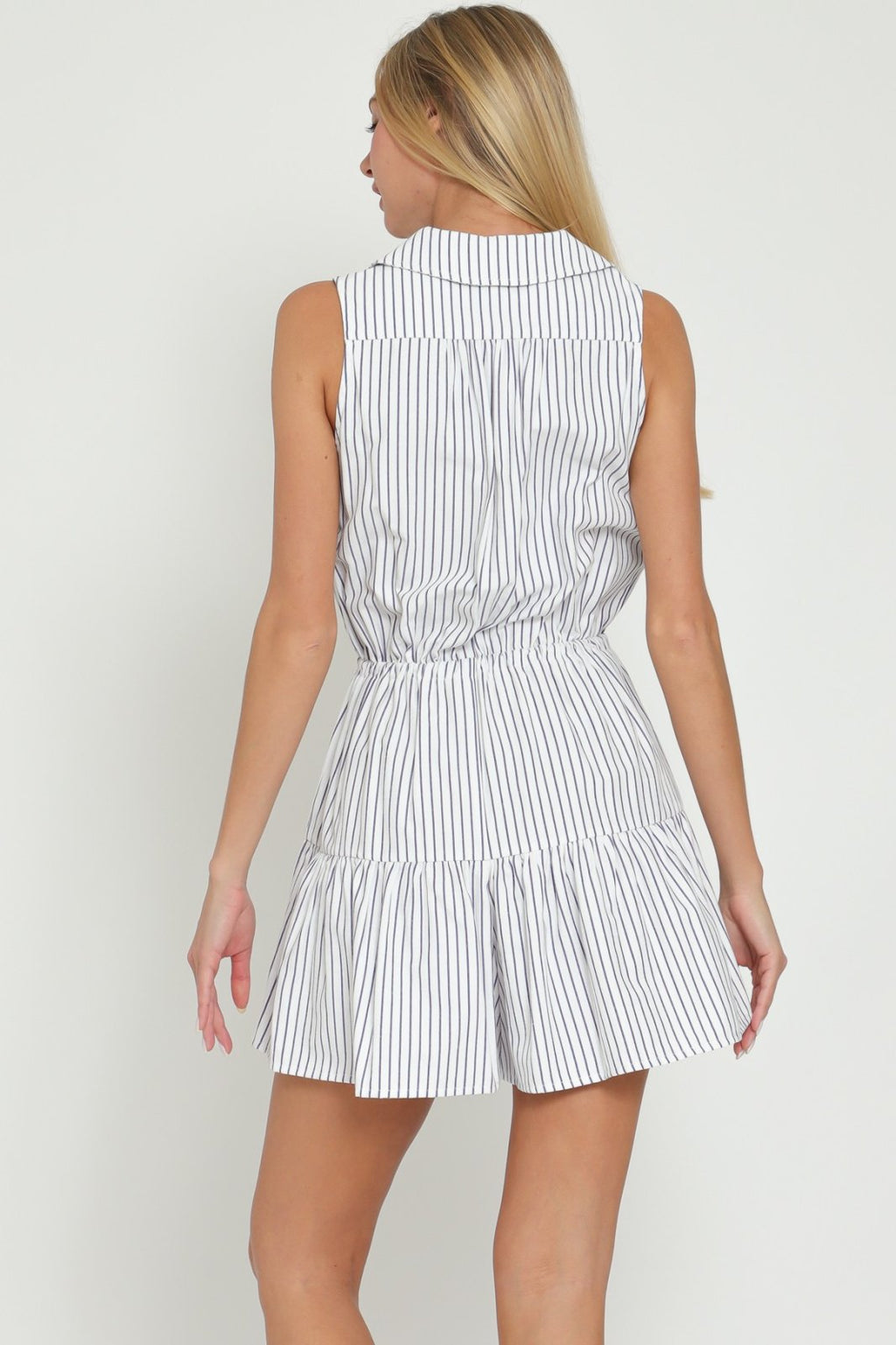Cora Romper from Port Aransas boutique, a stylish navy and white striped sleeveless jumpsuit, perfect for beach outings.