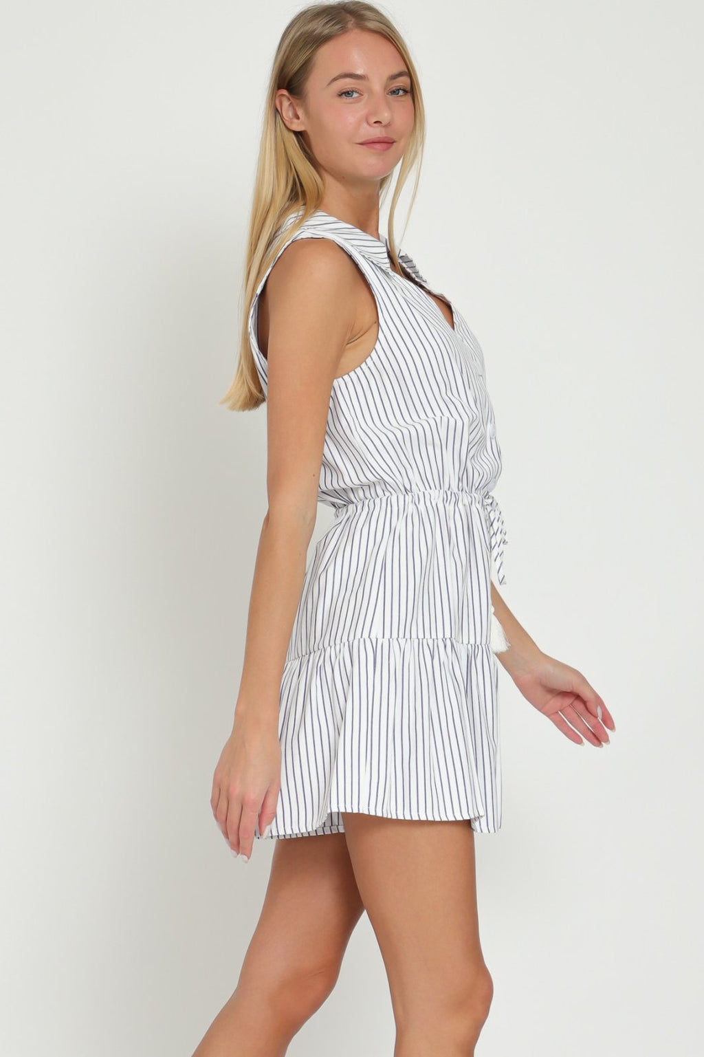 Navy and white striped Cora romper with tie waist, perfect for beach outings and casual summer days, from a coastal boutique.