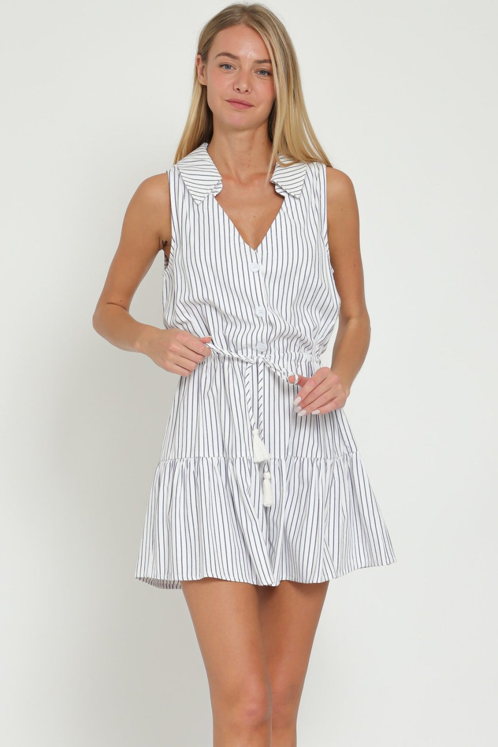Navy and white striped sleeveless Cora Romper featuring a button-down front and tie waist, perfect for summer outings.