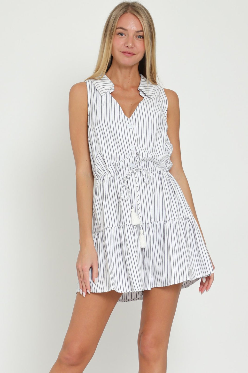 Chic navy and white striped Cora Romper with button-down front, tie waist, perfect for beach outings from a coastal boutique.