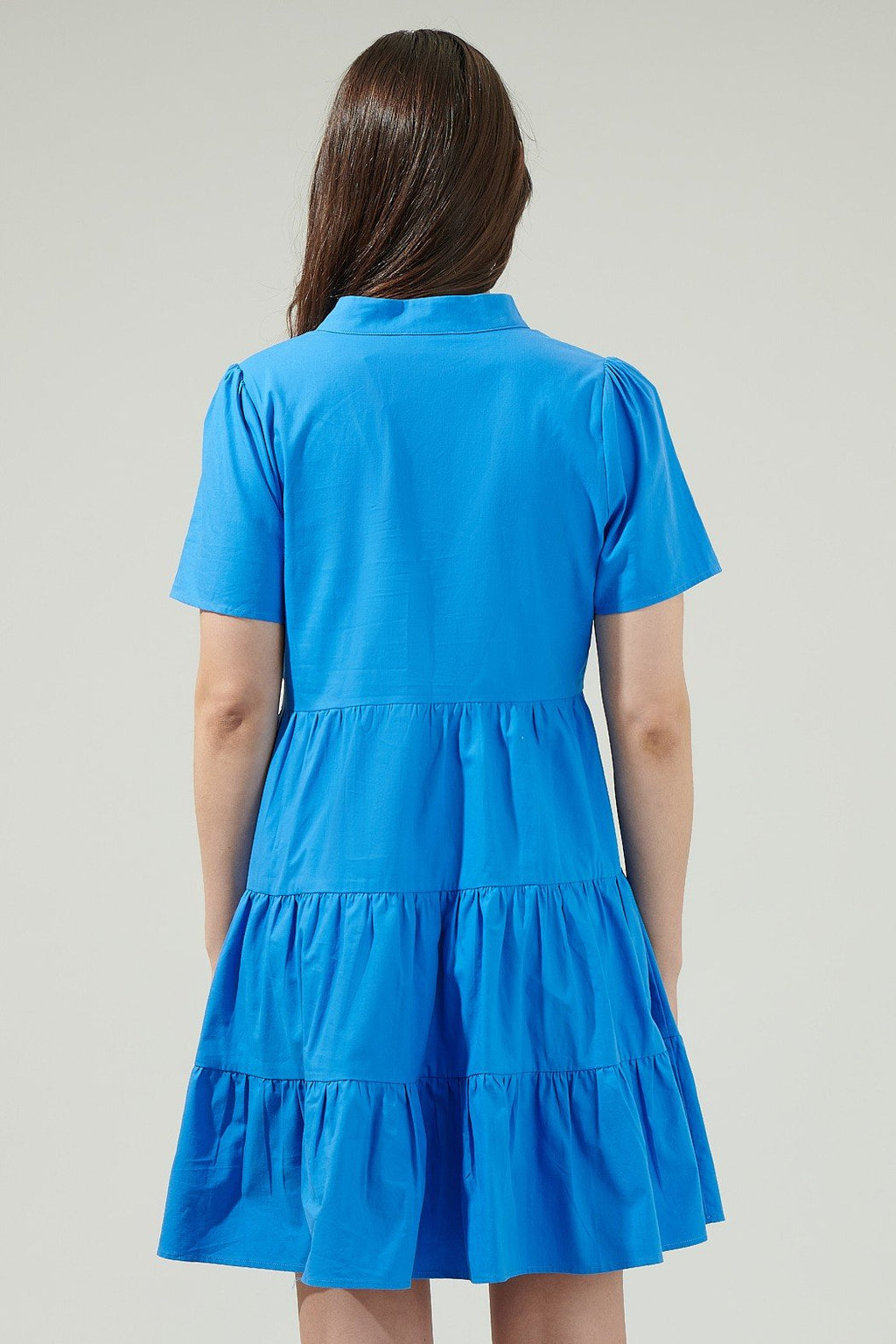 Back view of the Daytona Bay Dress, showcasing its tiered design and vibrant blue color from Raggdoll Boutique.