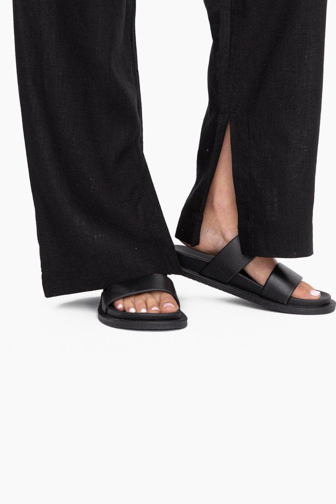 Stylish MONO B ATHLETIC PANT BLK/WHT paired with trendy black sandals for coastal fashion boutique look.