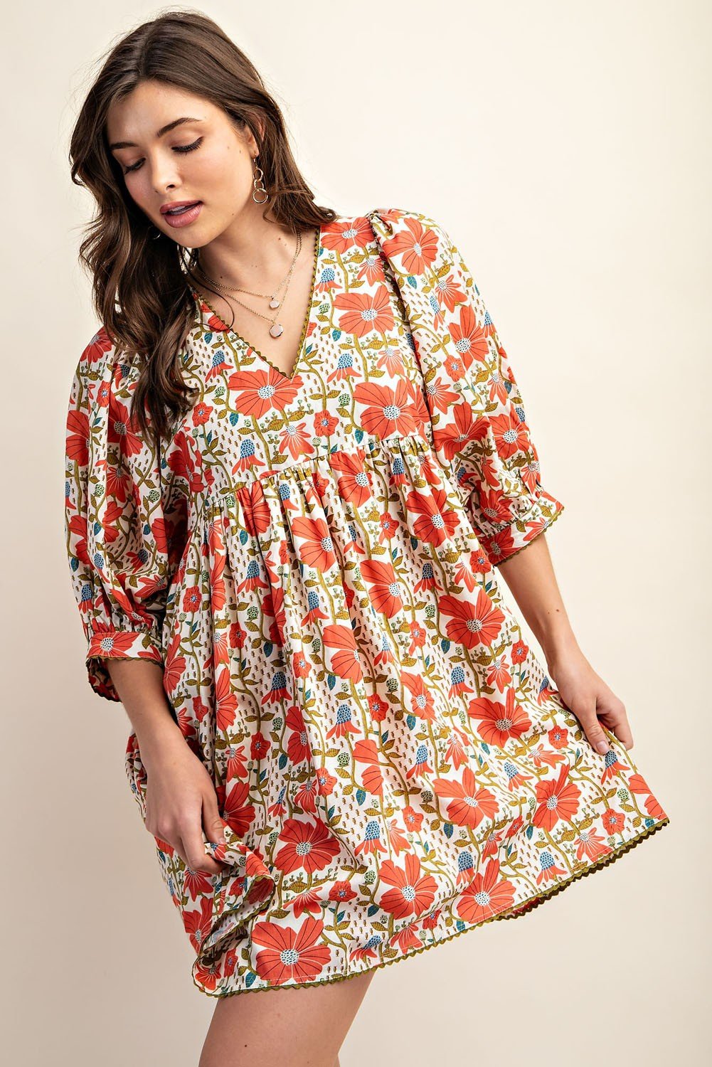 Vibrant floral Paige Dress perfect for tropical vacations from a Port Aransas coastal boutique, showcasing stylish women's fashion.