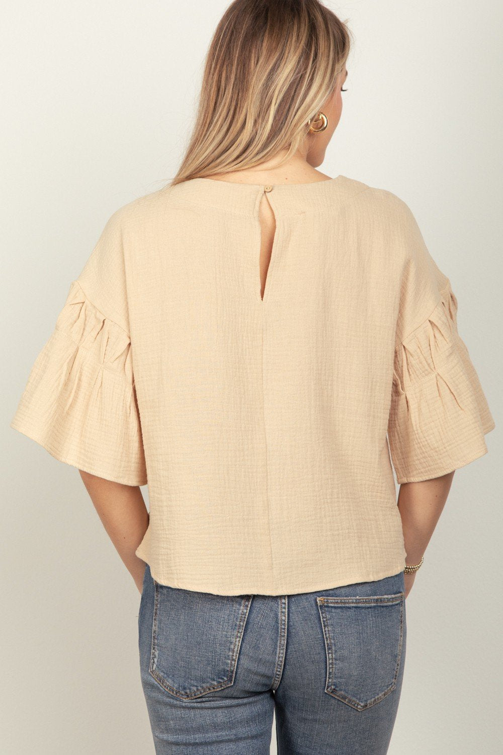 Stylish plus top with ruffled sleeves, perfect for beach dresses and coastal boutique clothing, ideal for tropical vacations.
