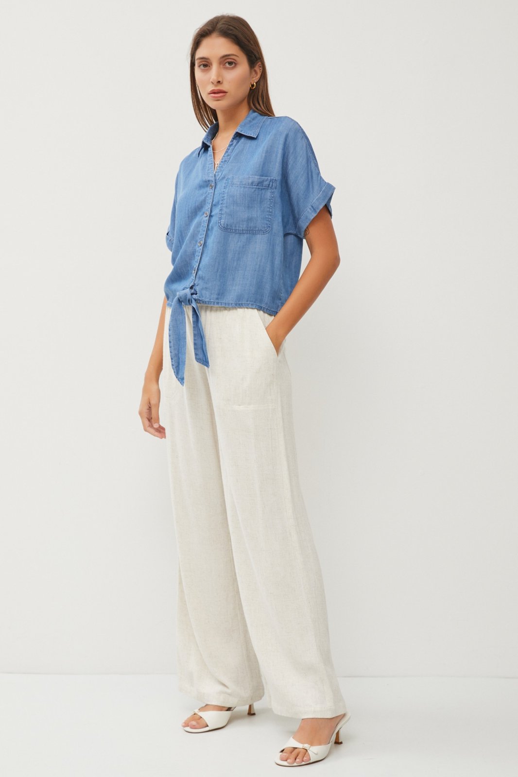 Medium Tencel Denim Tie-Front Top styled with light pants and sandals from Raggdoll Boutique.