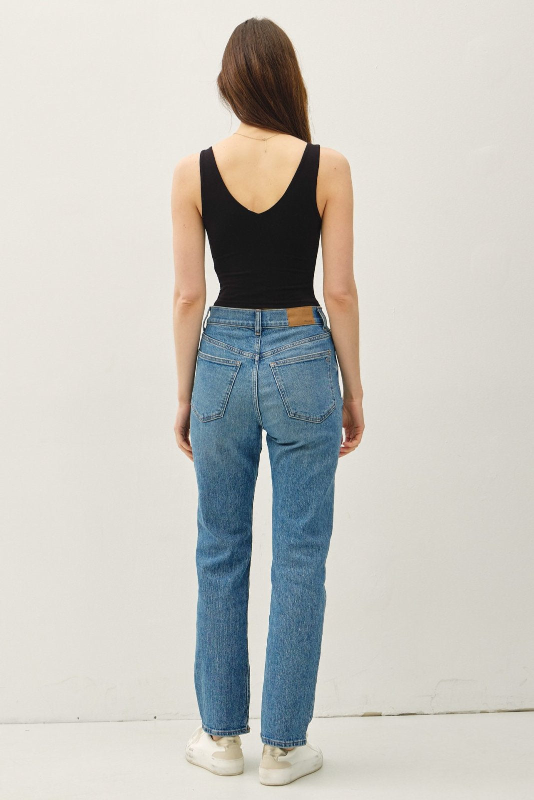 Stylish black crop tank top paired with trendy blue jeans, perfect for coastal boutique clothing and Port Aransas fashion.